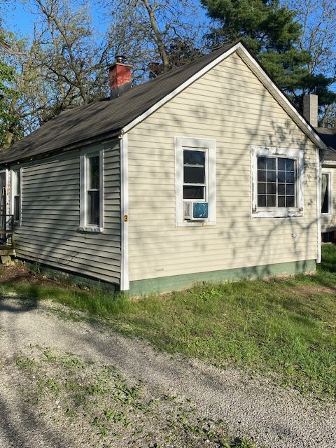 437 W Mount Morris St, Mount Morris, MI 48458 - view of property exterior with a chimney and cooling unit