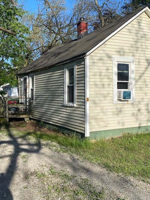 437 W Mount Morris St, Mount Morris, MI 48458 - view of home's exterior featuring a chimney and cooling unit