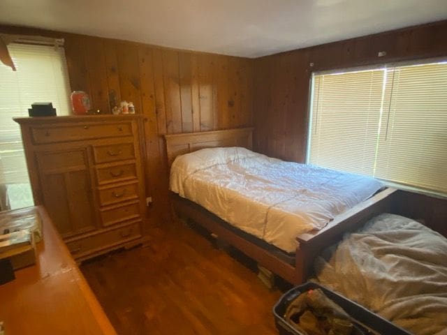 437 W Mount Morris St, Mount Morris, MI 48458 - bedroom featuring wooden walls and wood finished floors
