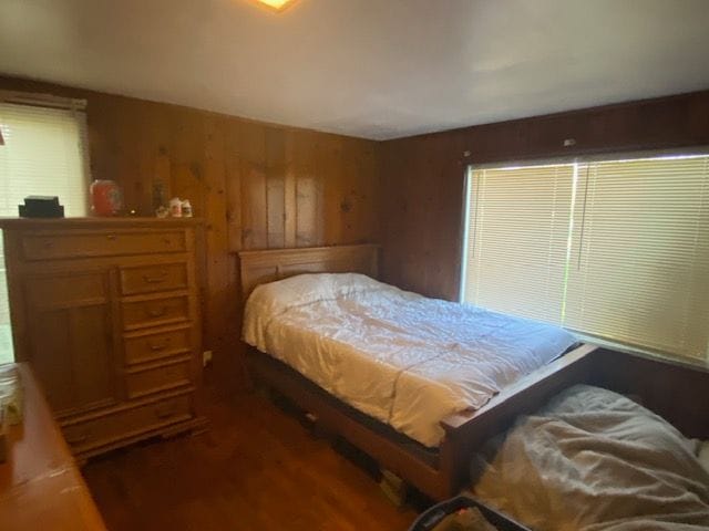 437 W Mount Morris St, Mount Morris, MI 48458 - bedroom with wood finished floors and wood walls