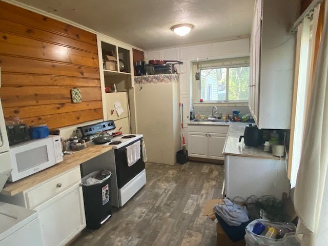 437 W Mount Morris St, Mount Morris, MI 48458 - kitchen with white appliances, a sink, dark wood-style floors, and light countertops