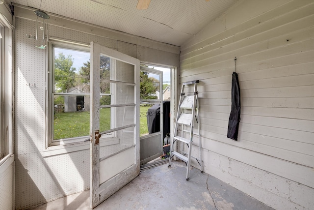 sunroom / solarium with healthy amount of natural light and a ceiling fan