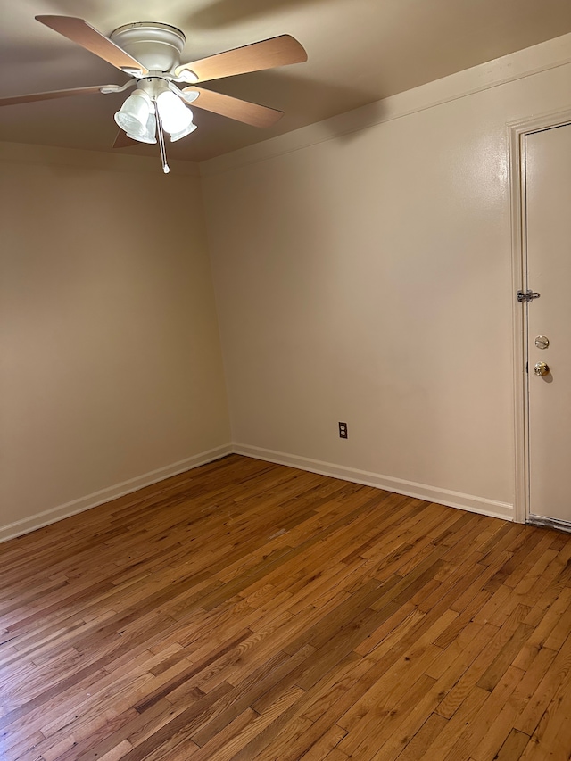 unfurnished room with wood-type flooring, ceiling fan, and baseboards