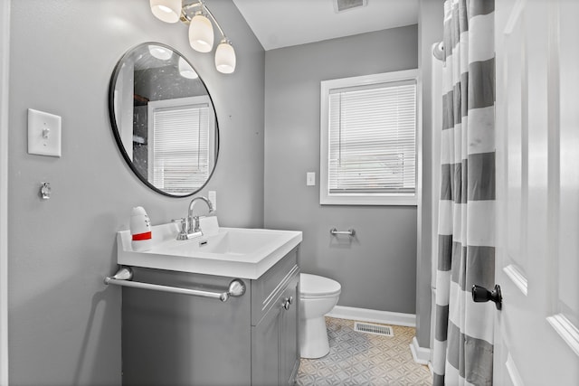 bathroom with baseboards, toilet, vanity, a shower with curtain, and tile patterned floors