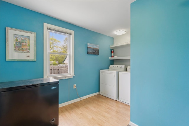 7244 Neff Rd, Mount Morris, MI 48458 - laundry area with separate washer and dryer, light wood-style flooring, and baseboards