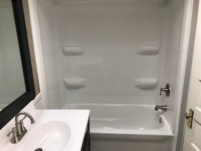 full bathroom featuring vanity and bathtub / shower combination
