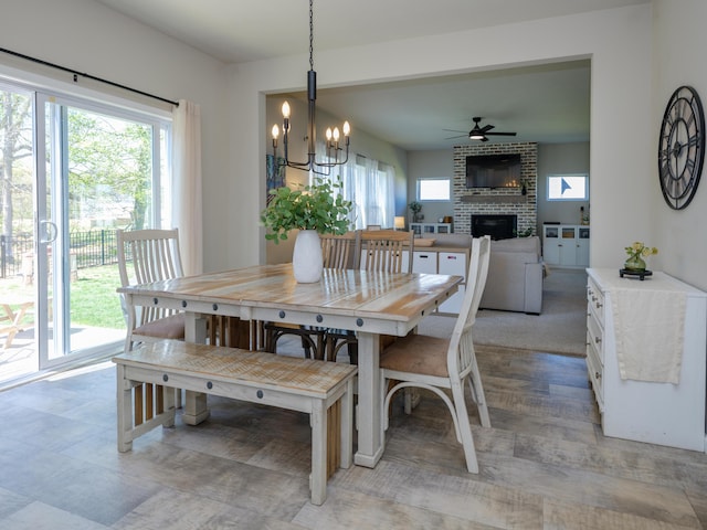 59376 Silvergrass Ave, Mattawan, MI 49071 - dining space featuring a brick fireplace, ceiling fan, and a chandelier