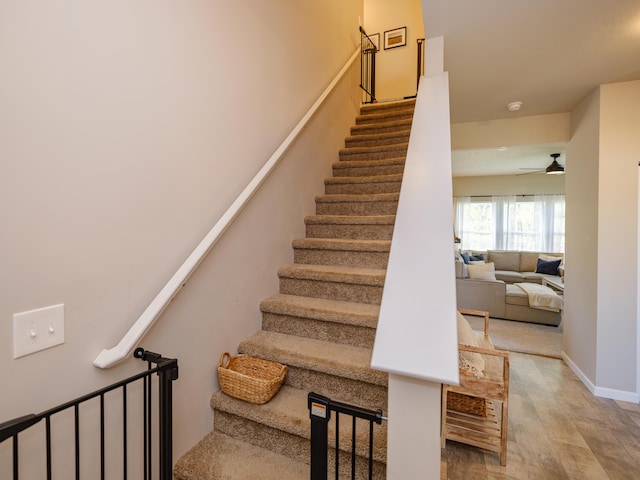 59376 Silvergrass Ave, Mattawan, MI 49071 - staircase featuring a ceiling fan, wood finished floors, and baseboards