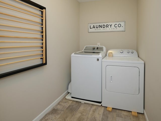 59376 Silvergrass Ave, Mattawan, MI 49071 - laundry room with independent washer and dryer, light wood-style floors, and baseboards