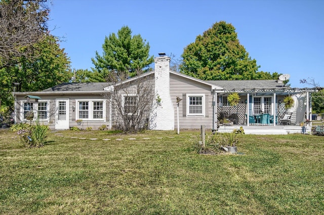 10186 Carlee June Dr, Fenton, MI 48430 - back of house with a chimney, a lawn, a patio area, and a pergola