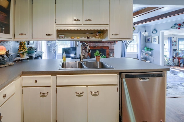 10186 Carlee June Dr, Fenton, MI 48430 - kitchen with stainless steel dishwasher, a sink, wood finished floors, white cabinetry, and beamed ceiling