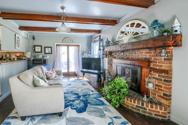 10186 Carlee June Dr, Fenton, MI 48430 - living area featuring beamed ceiling, hardwood / wood-style floors, crown molding, a fireplace, and baseboards