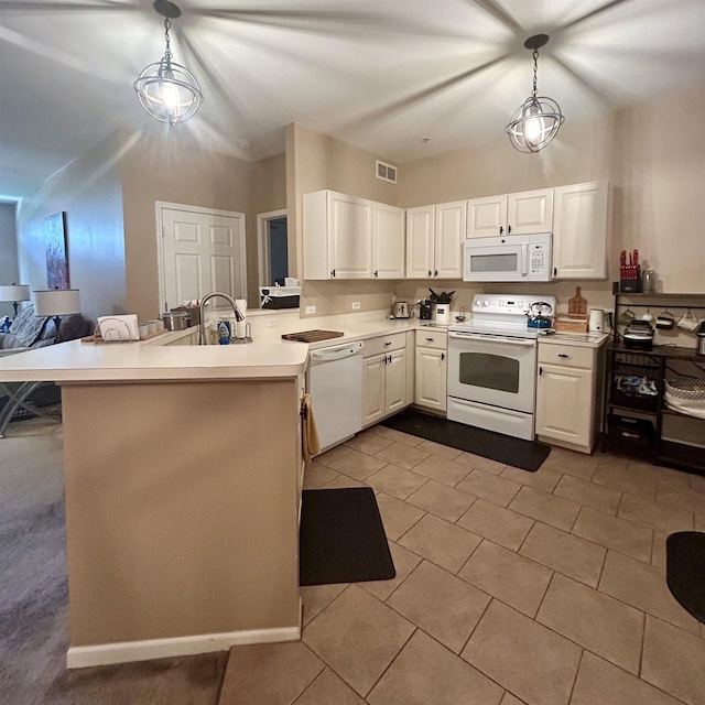 kitchen with white appliances, a peninsula, a sink, light countertops, and white cabinetry
