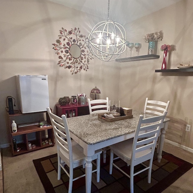 carpeted dining room with a chandelier and baseboards