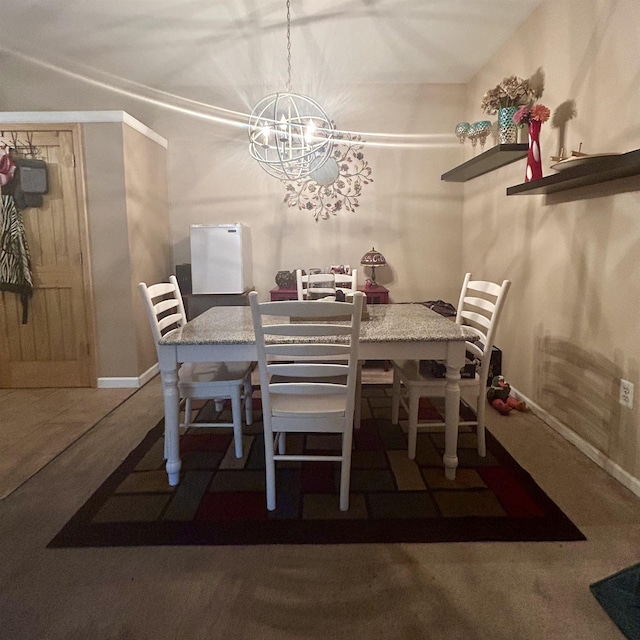 dining space with a chandelier and baseboards