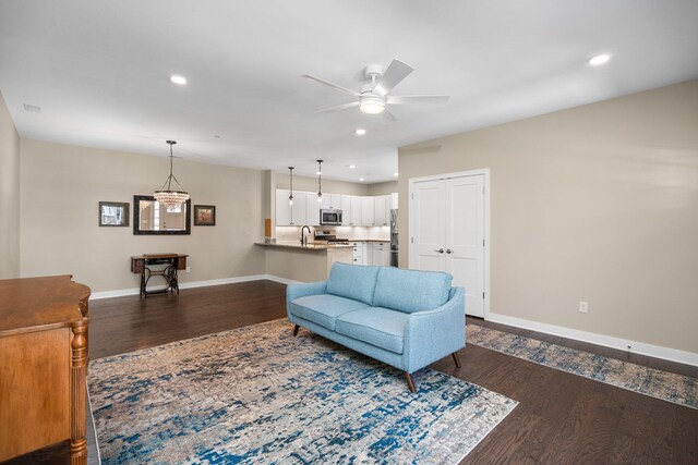 611 Woodland Dr, Dexter, MI 48130 - living room featuring dark wood-style floors, baseboards, ceiling fan, and recessed lighting