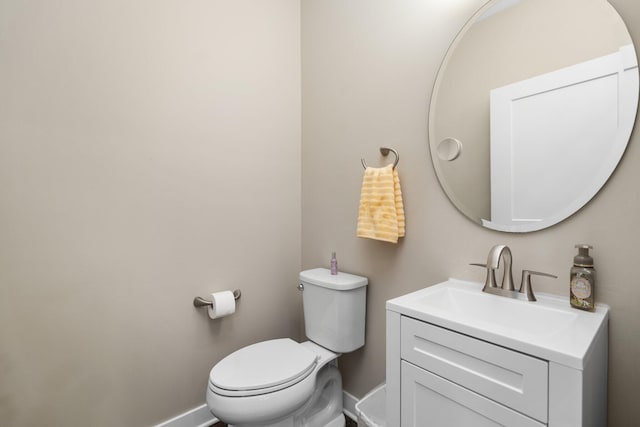 611 Woodland Dr, Dexter, MI 48130 - half bathroom featuring toilet, vanity, and baseboards