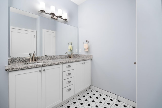 611 Woodland Dr, Dexter, MI 48130 - bathroom featuring double vanity, baseboards, and tile patterned flooring