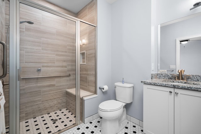 611 Woodland Dr, Dexter, MI 48130 - bathroom with a shower stall, vanity, toilet, tile patterned floors, and baseboards