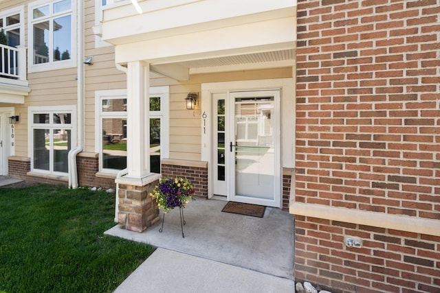 611 Woodland Dr, Dexter, MI 48130 - doorway to property with brick siding