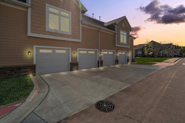 611 Woodland Dr, Dexter, MI 48130 - view of home's exterior with an attached garage and concrete driveway