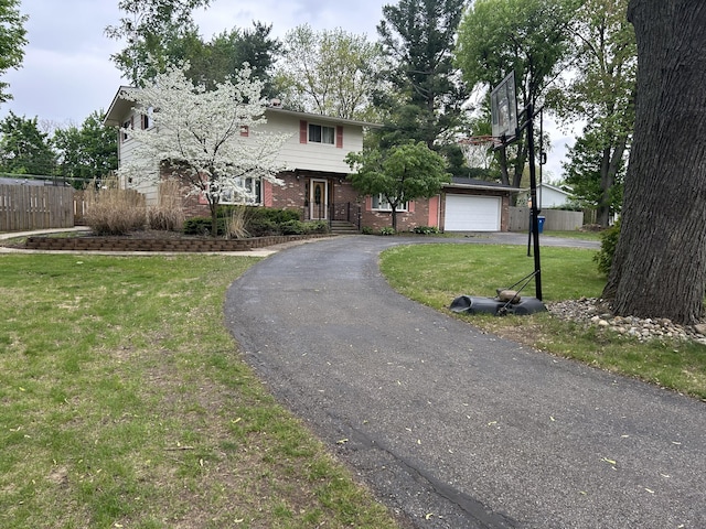 29 Douglas Ave, Coldwater, MI 49036 - view of front facade with asphalt driveway, brick siding, and an attached garage