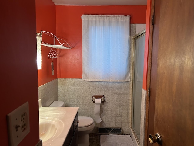 29 Douglas Ave, Coldwater, MI 49036 - full bathroom with a stall shower, toilet, tile patterned flooring, vanity, and tile walls