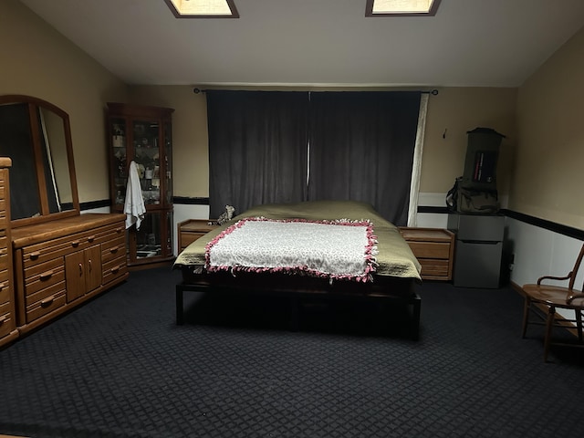 29 Douglas Ave, Coldwater, MI 49036 - bedroom with lofted ceiling, dark carpet, and freestanding refrigerator