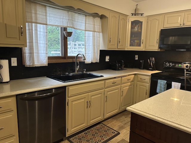 29 Douglas Ave, Coldwater, MI 49036 - kitchen featuring black appliances, a sink, light countertops, and backsplash