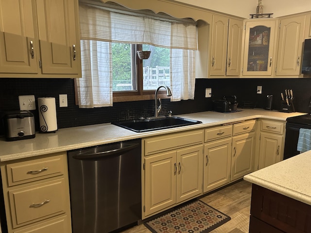 29 Douglas Ave, Coldwater, MI 49036 - kitchen with appliances with stainless steel finishes, a sink, light countertops, backsplash, and glass insert cabinets