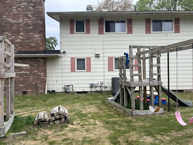29 Douglas Ave, Coldwater, MI 49036 - back of house with a yard, central air condition unit, and a chimney