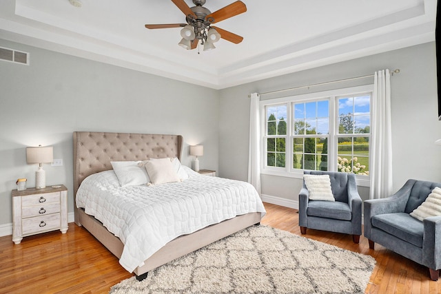 7812 Fountain Hills Ln, Davisburg, MI 48350 - bedroom featuring a raised ceiling, light wood-style flooring, and baseboards
