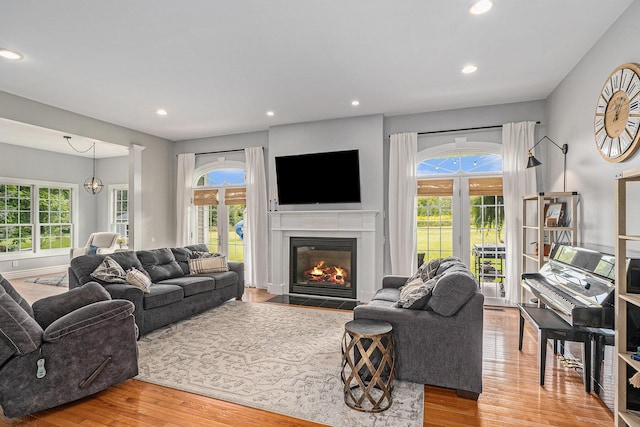 7812 Fountain Hills Ln, Davisburg, MI 48350 - living area with wood finished floors, healthy amount of natural light, a fireplace with flush hearth, and recessed lighting
