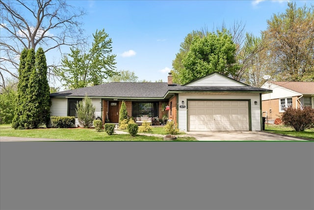 1075 E Hill Rd, Grand Blanc, MI 48439 - ranch-style house with an attached garage, a chimney, driveway, a front lawn, and brick siding