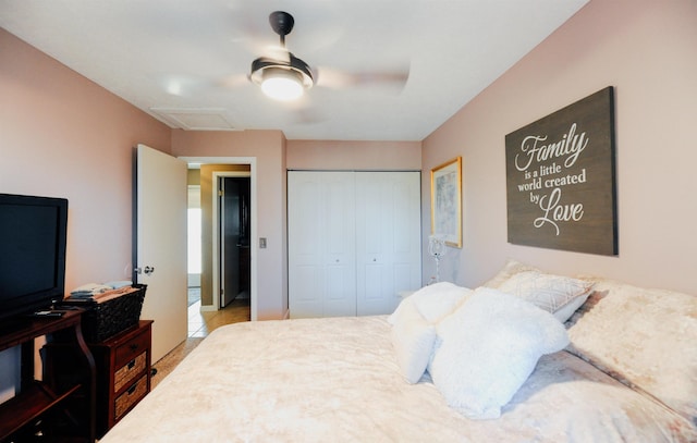 bedroom featuring attic access, a closet, and a ceiling fan