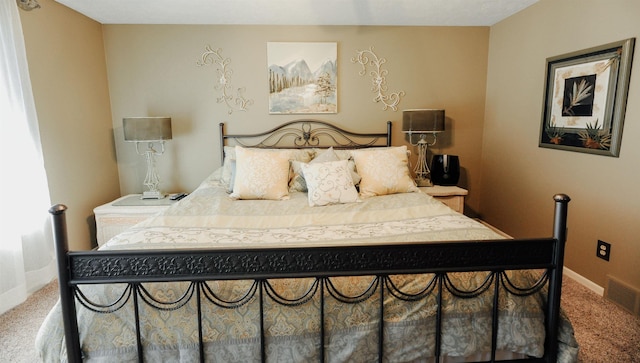 bedroom featuring carpet floors and baseboards