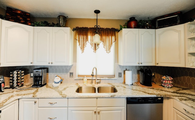 kitchen with dishwasher, a sink, white cabinetry, and light stone countertops