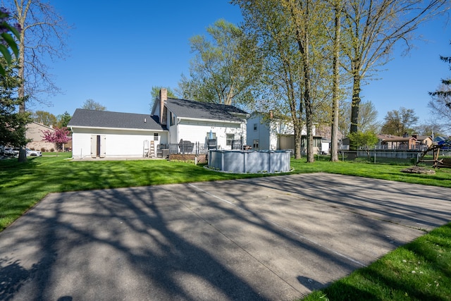 472 Central St, Marysville, MI 48040 - back of property with an outdoor pool and a chimney