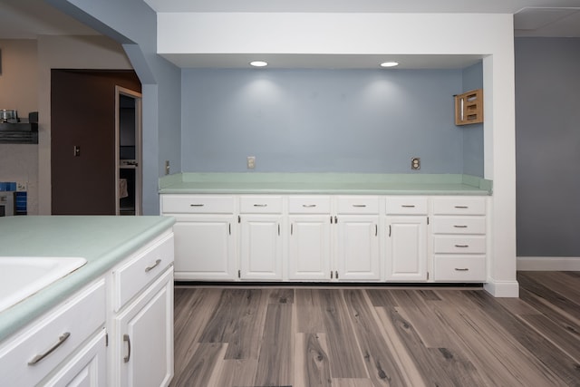 472 Central St, Marysville, MI 48040 - kitchen with light countertops, dark wood finished floors, white cabinets, a sink, and recessed lighting