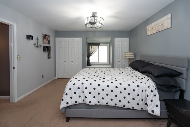 472 Central St, Marysville, MI 48040 - bedroom featuring multiple closets, carpet, baseboards, and a chandelier