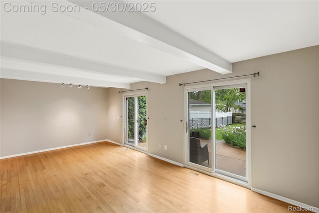 16233 Birwood Ave, Beverly Hills, MI 48025 - unfurnished room with light wood-style floors, beam ceiling, and baseboards