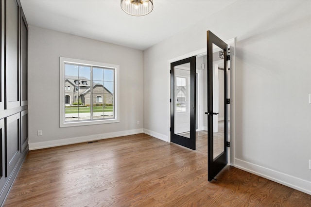 19266 Thompson Dr, Macomb, MI 48042 - foyer entrance featuring french doors, wood finished floors, baseboards, and a chandelier