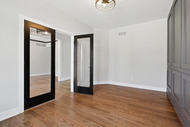 19266 Thompson Dr, Macomb, MI 48042 - unfurnished bedroom with wood finished floors and baseboards