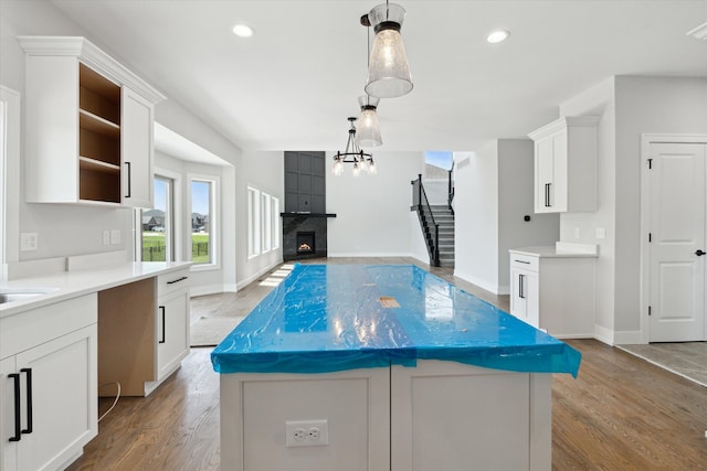 19266 Thompson Dr, Macomb, MI 48042 - kitchen with open shelves, light wood-style flooring, white cabinets, and recessed lighting