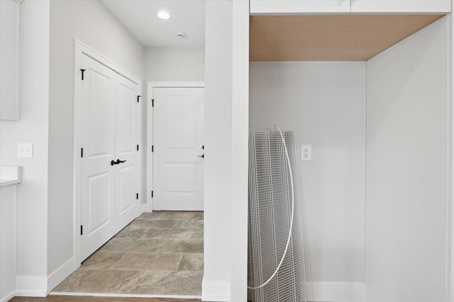 19266 Thompson Dr, Macomb, MI 48042 - hallway featuring a heating unit, baseboards, stone finish flooring, and recessed lighting