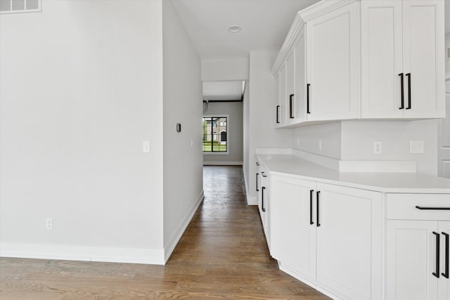 19266 Thompson Dr, Macomb, MI 48042 - kitchen with baseboards, light countertops, wood finished floors, white cabinetry, and recessed lighting
