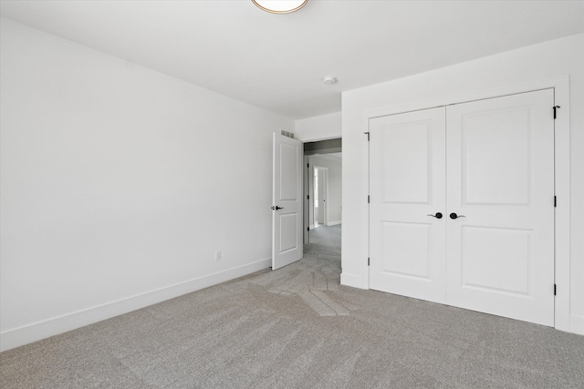 19266 Thompson Dr, Macomb, MI 48042 - unfurnished bedroom with light carpet, a closet, and baseboards