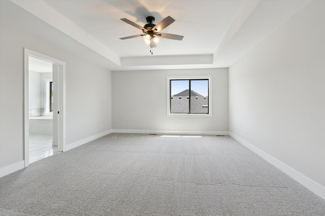 19266 Thompson Dr, Macomb, MI 48042 - empty room with a raised ceiling, a ceiling fan, light colored carpet, and baseboards
