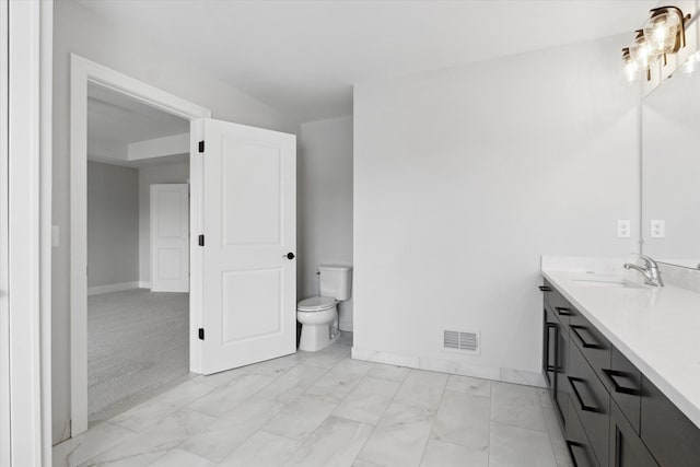 19266 Thompson Dr, Macomb, MI 48042 - bathroom featuring marble look tiles, toilet, vanity, and baseboards