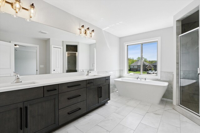 19266 Thompson Dr, Macomb, MI 48042 - full bathroom with marble finish floors, a shower stall, double vanity, tile walls, and a soaking tub